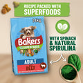 A 14kg bag of Purina Bakers Adult with Beef dog food is shown on a wooden board with promotional text and ingredient callouts, including 'With Spinach & Natural Spirulina' and green treat pieces.