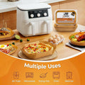 White air fryer on a kitchen counter with various food items and packaging, labeled 'Multiple Uses'.