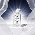 Bottle of WOW Haircare product with text 'The OG Frizz-Fighter' and '25 Major Beauty Awards' on a dark background.