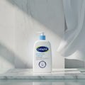 Cetaphil Gentle Skin Cleanser bottle with branding and product details on a light gray background