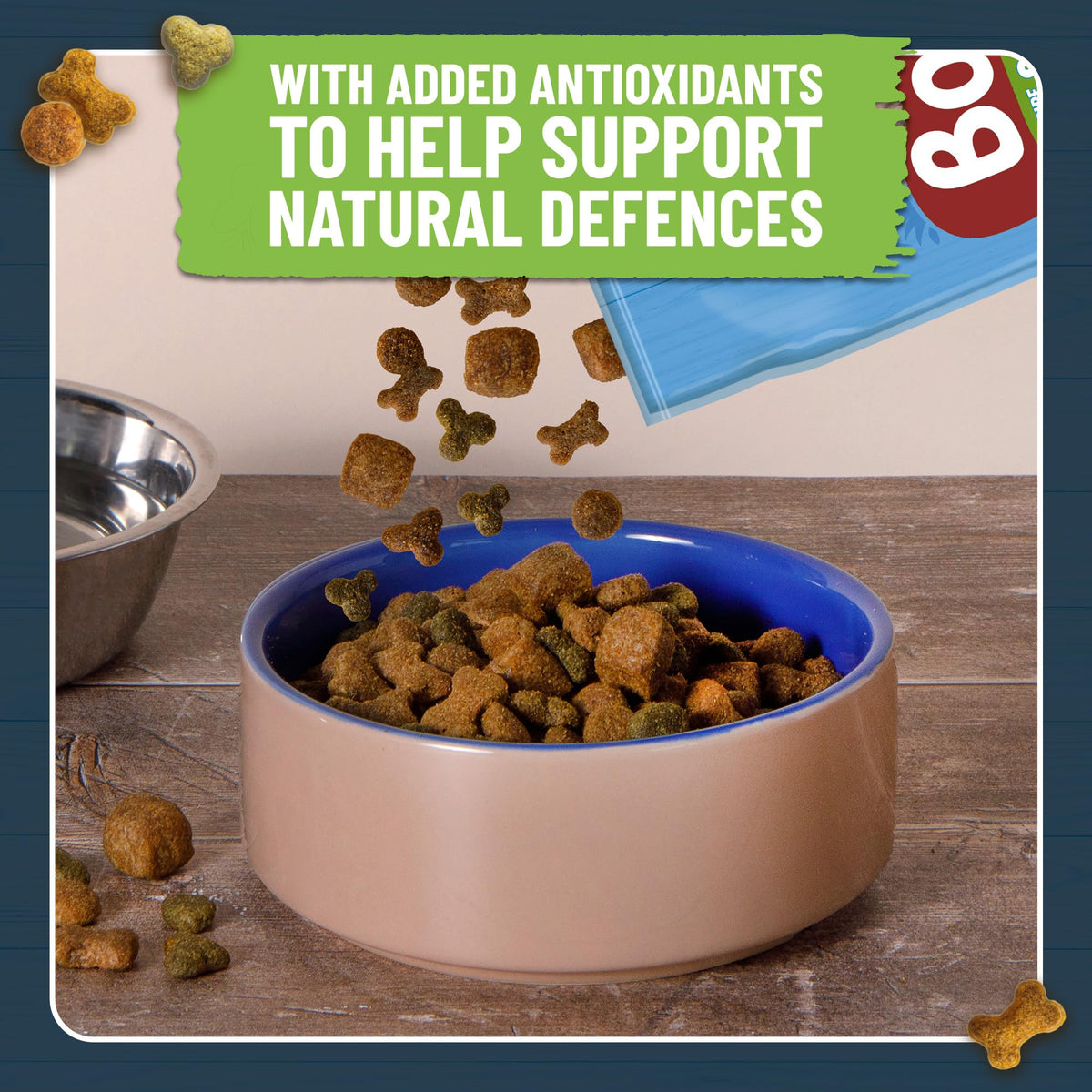 Dog food in a bowl with text about added antioxidants on a wooden floor.