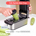 Veggie slicer with a 1.2L family size tray being used to slice a zucchini.