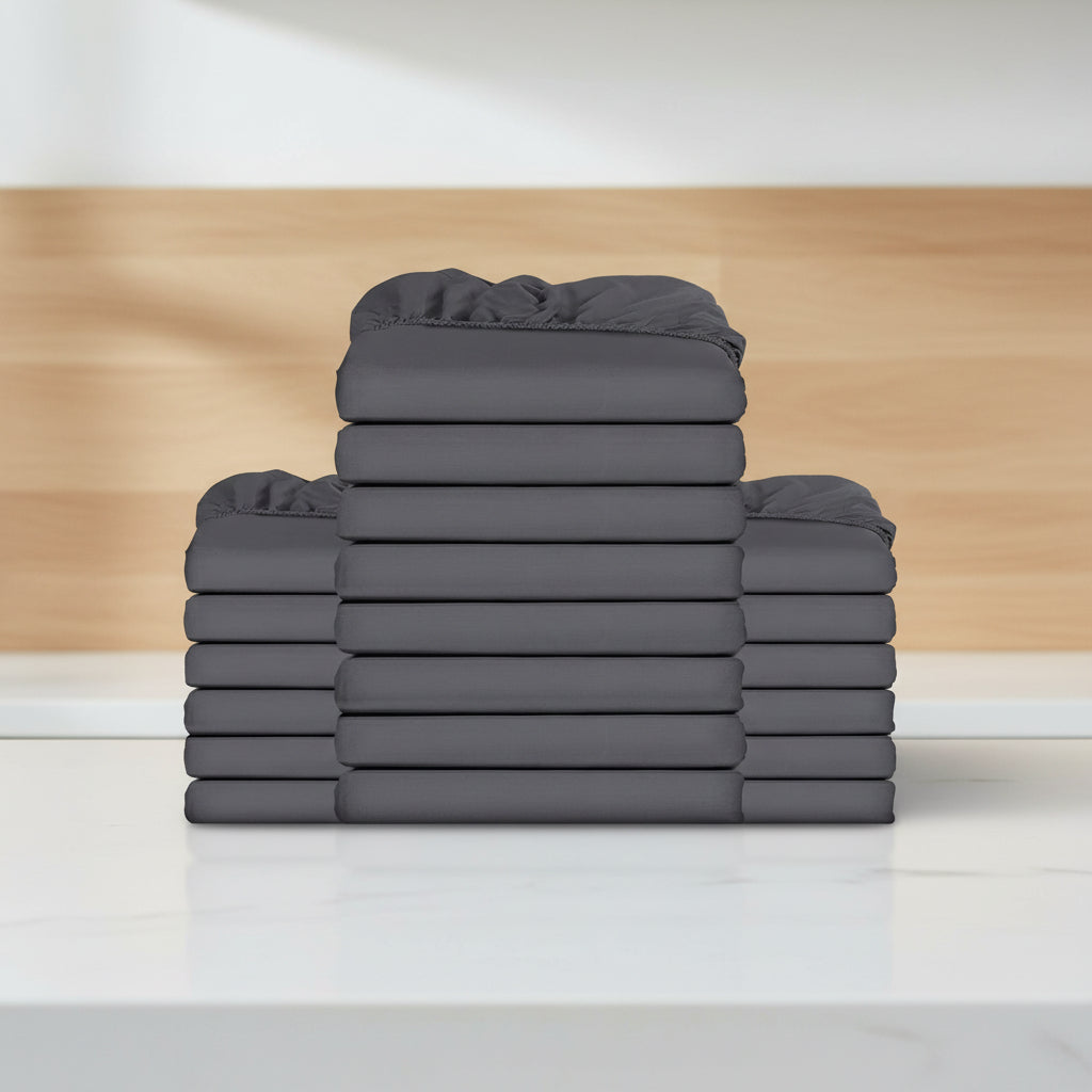 Stack of gray fitted sheets on a white background