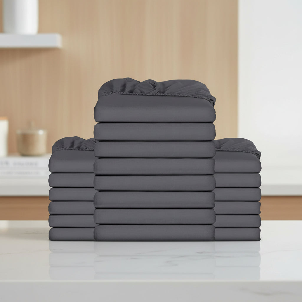 Stack of gray fitted sheets on a white background