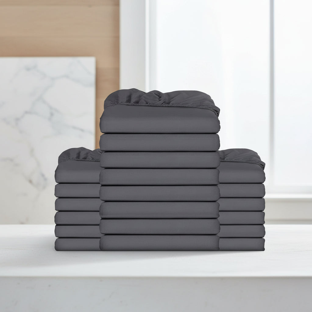 Stack of gray fitted sheets on a white background