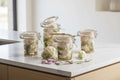 Jars of pickled vegetables on a wooden surface with a dark background
