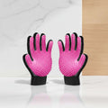 A pair of pet grooming gloves with bright pink silicone palm sides featuring soft bristles and black textured finger and wrist sections, shown on a white background.