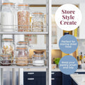 Kitchen shelving unit with glass jars storing dried food, labeled 'Store Style Create'.