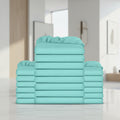 A stack of folded sheets in a solid mint green or aqua color, arranged symmetrically with one tall central stack and two shorter stacks on each side, isolated on a white background.