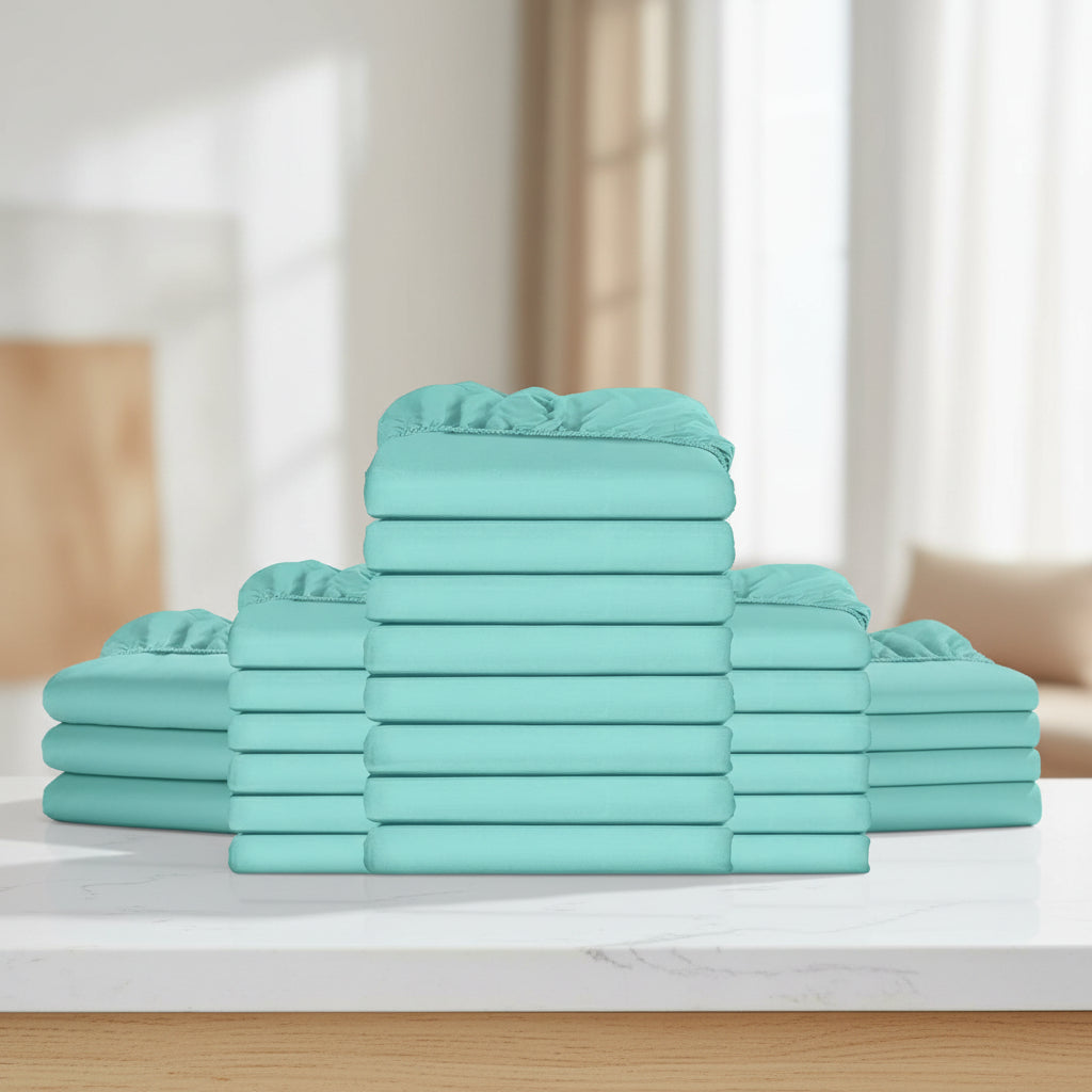A stack of folded sheets in a solid mint green or aqua color, arranged symmetrically with one tall central stack and two shorter stacks on each side, isolated on a white background.