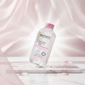 Garnier SkinActive Micellar Cleansing Water bottle on a pink water background