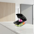 Black vegetable slicer with various attachments and sliced vegetables displayed around it, featuring the brand 'fullstar'.