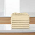 Stack of beige folded towels on a white background