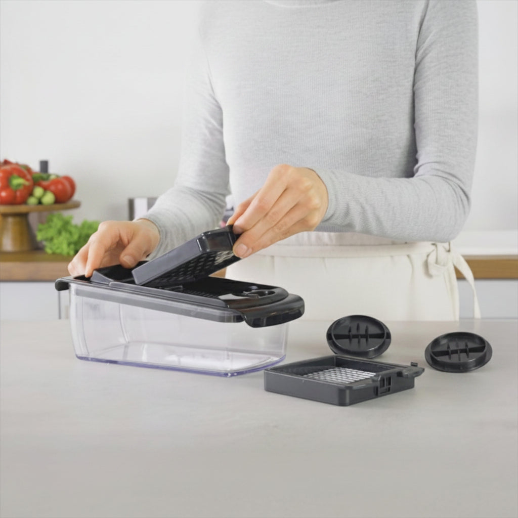 Person using a kitchen chopper with 'fullstar' branding on a kitchen counter.