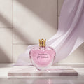 Vera Wang Princess perfume bottle with a woman holding a large crown on a dark background